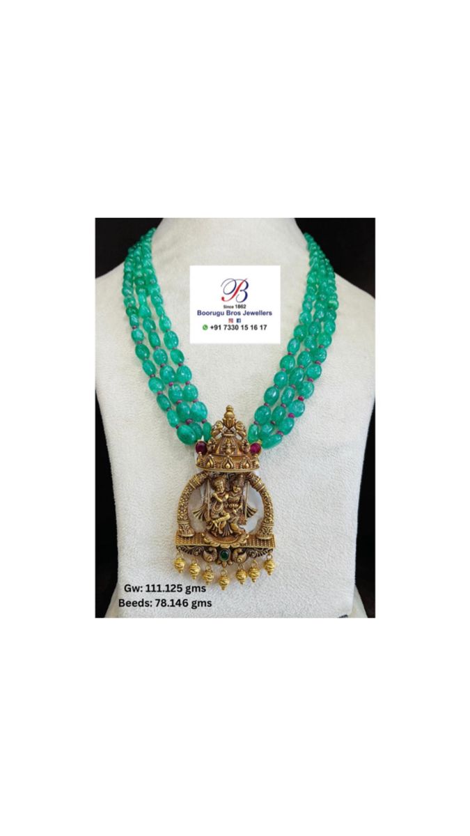 a necklace with green beads and a gold crown