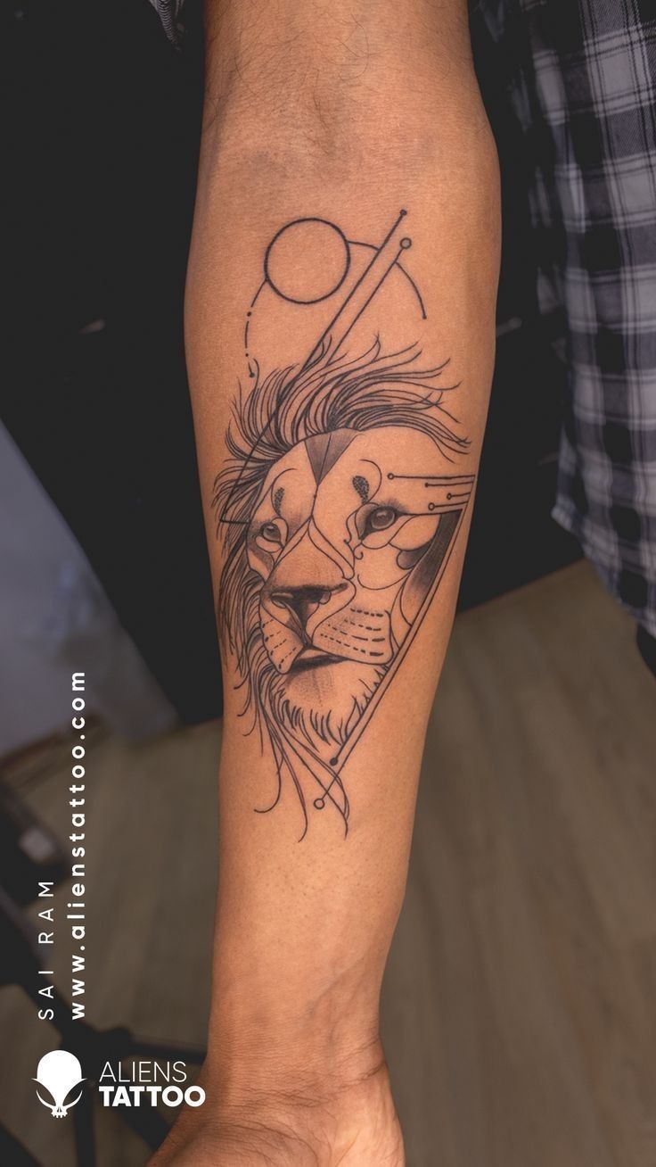 a man's arm with a lion tattoo on the forearm and an arrow in the middle