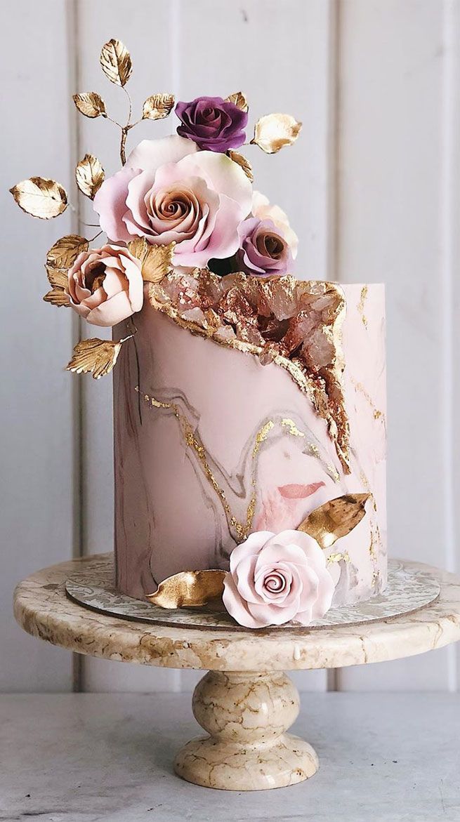 a pink and gold cake with flowers on top is featured in the cover of more magazine