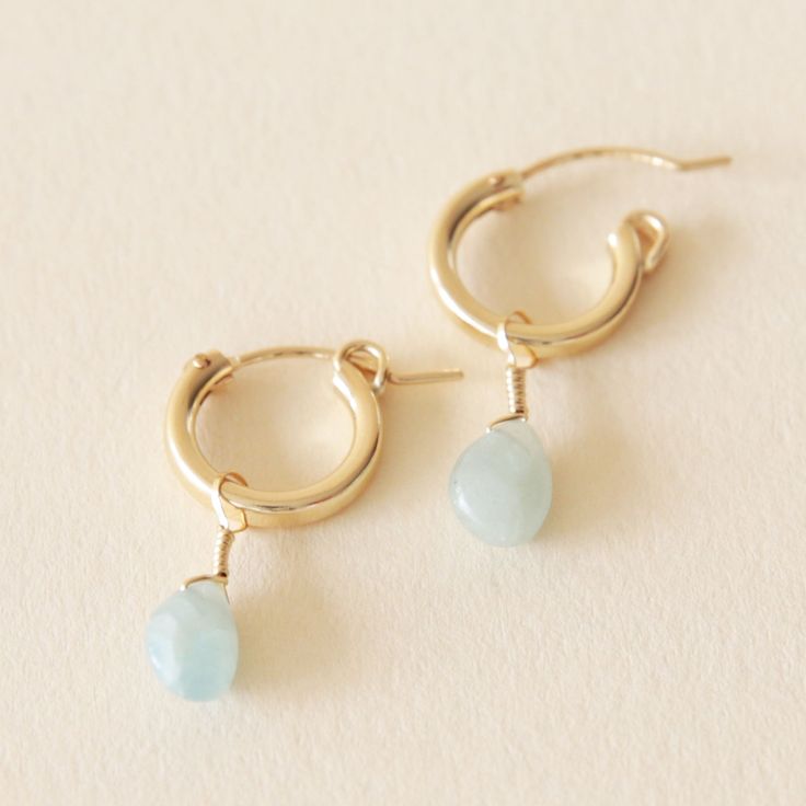 Aquamarine, a water element stone, is a calming stone said to be good for emotional centering. Encouraging selflessness and empathy, this gemstone balances energy and soothes the soul. Crafted with 14k gold filled materials, these minimalist huggie earrings are gentle on the ears and built to last. Match them with any Kindness Gems necklace for a show stopping look! Material | 14k gold filled Stone | Aquamarine Hypoallergenic 14k Gold Filled Dangle Huggie Earrings, Dainty Crystal Jewelry, Yellow Gold Gemstone Huggie Earrings For Everyday, Everyday Yellow Gold Huggie Earrings With Birthstone, Delicate 14k Gold Filled Hypoallergenic Huggie Earrings, Dainty Teardrop Huggie Earrings For Everyday, Everyday Dainty Teardrop Huggie Earrings, Delicate 14k Gold Filled Huggie Earrings For Everyday, Minimalist Everyday Earrings With Birthstone