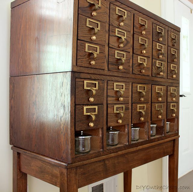 an old wooden cabinet with many drawers and knobs on the front, in a home