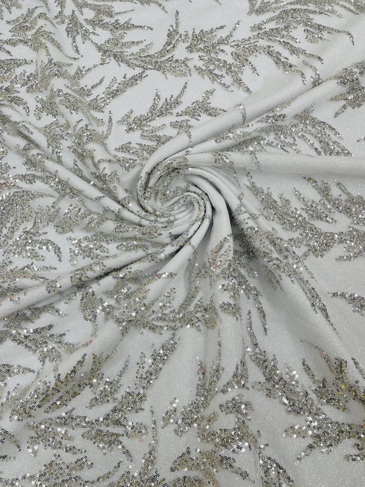 white fabric with silver sequins on it