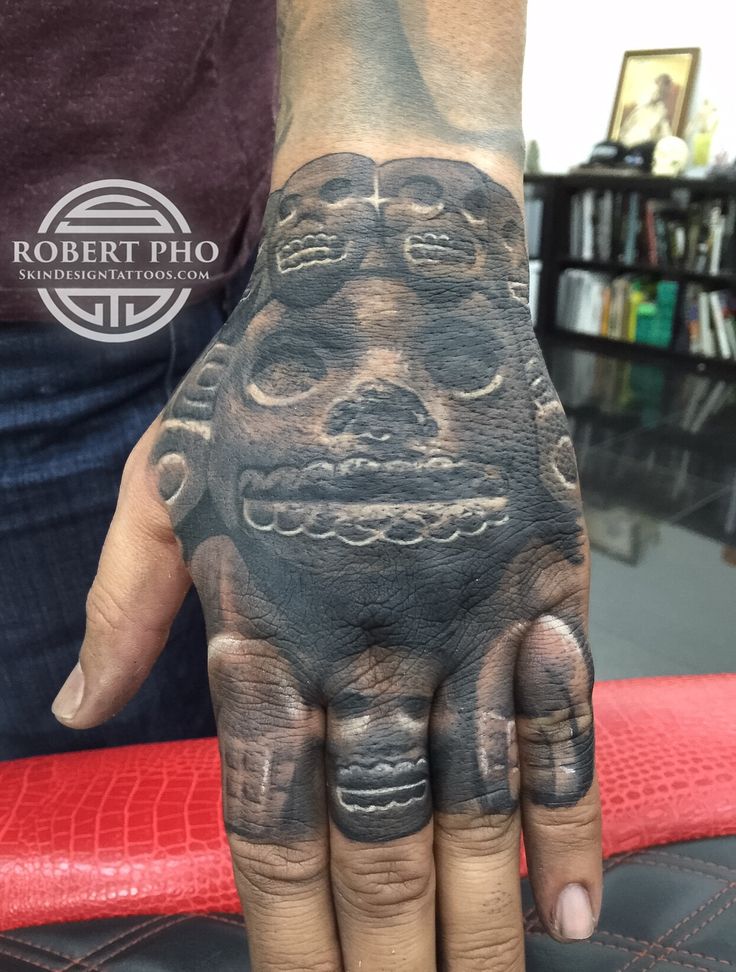 a person with a tattoo on their hand