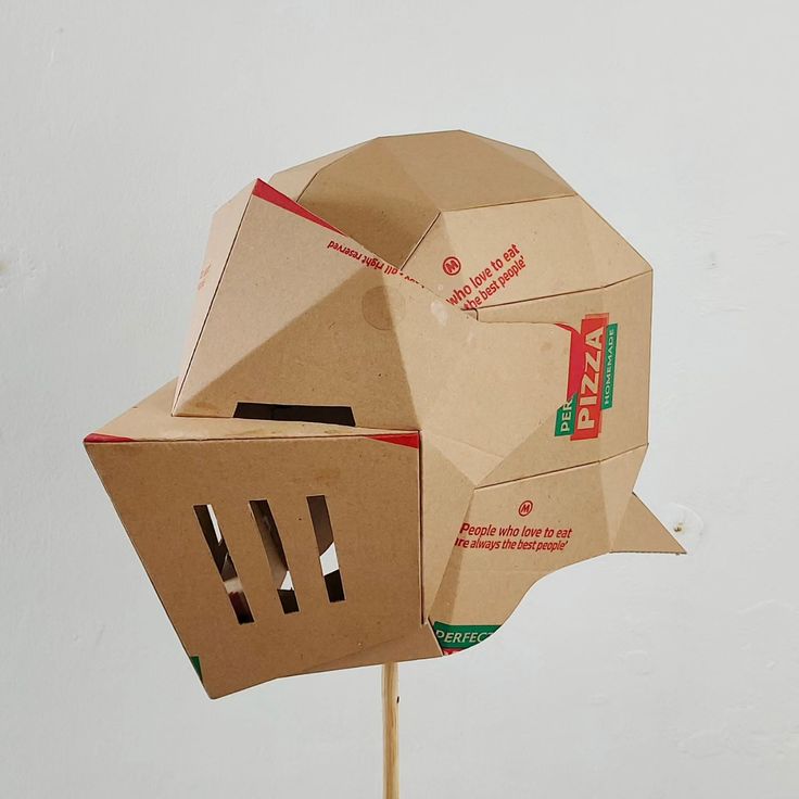 a pizza box shaped like a human head on top of a toothpick stick