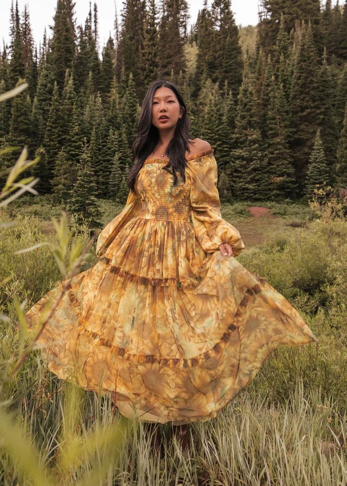 You're So GoldenStep into sunshine with the Sunflower Fields Dress. This radiant design features long, flowing sleeves and a smocked bodice for a comfortable, flattering fit. The vibrant yellow fabric is adorned with a beautiful sunflower print, ... Fantasy Aesthetic Clothes, You're So Golden, Flowing Sleeves, Sunflower Dress, Gala Events, The Sunflower, Sunflower Fields, Dreamy Dress, Sunflower Print