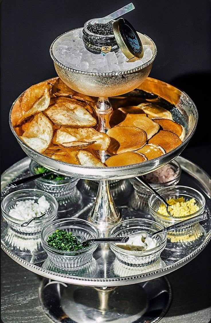 three tiered platter filled with different types of food