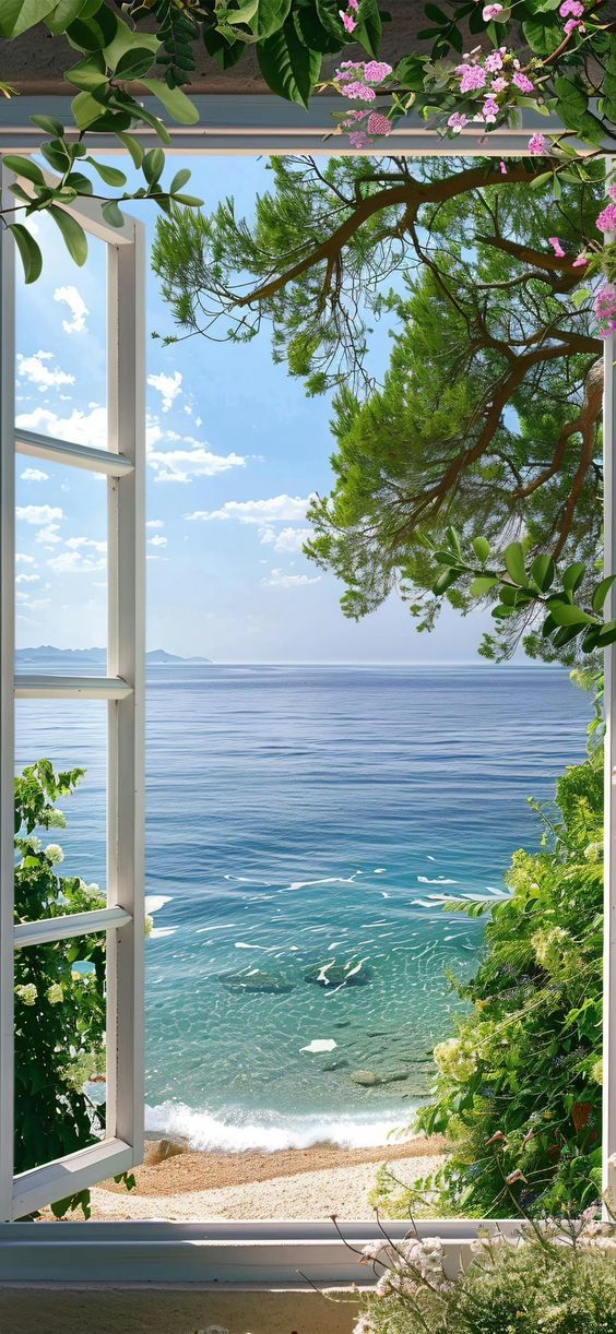 an open window overlooking the ocean with pink flowers in bloom and greenery on either side