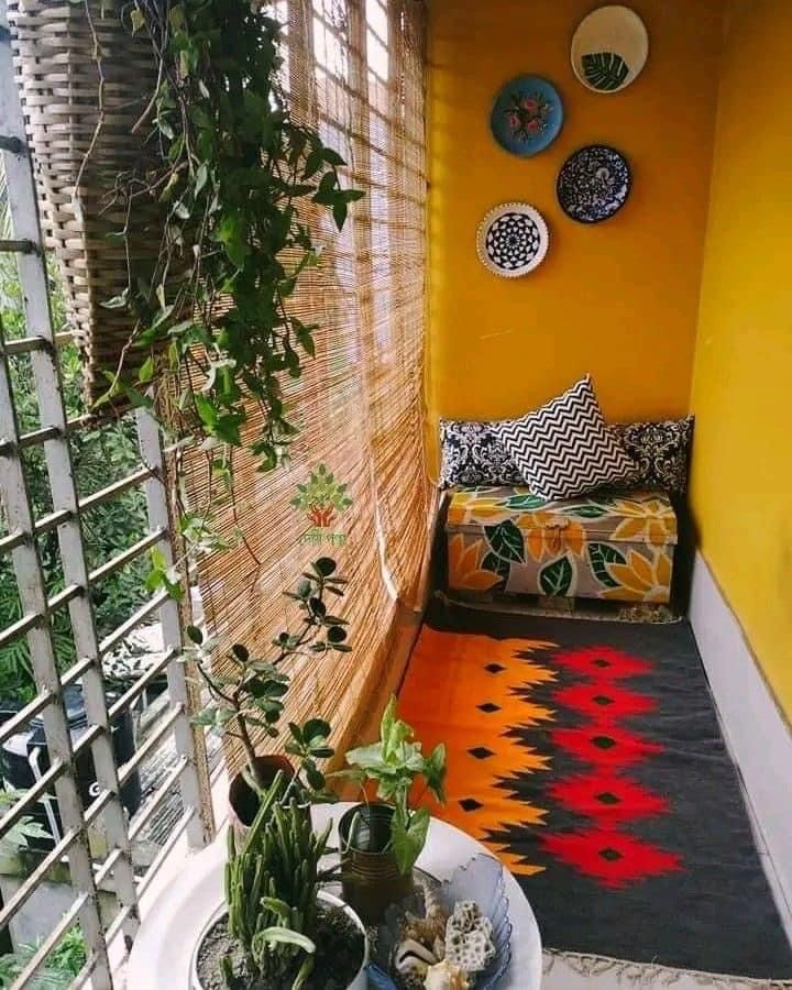 a balcony with potted plants and plates on the wall