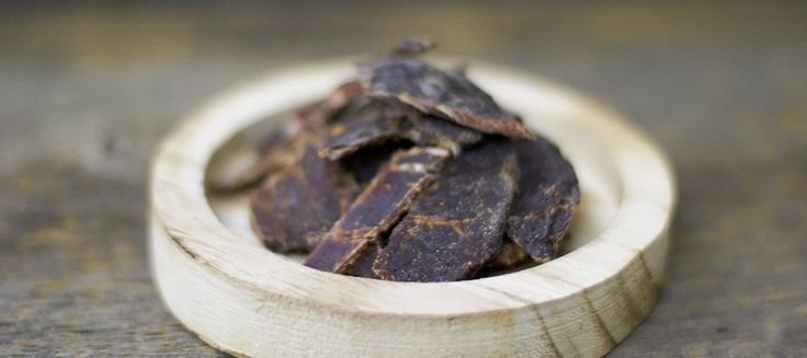 a small wooden bowl filled with dried fruit