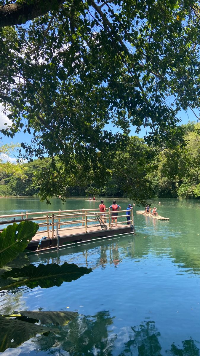 people are on a dock in the middle of a lake