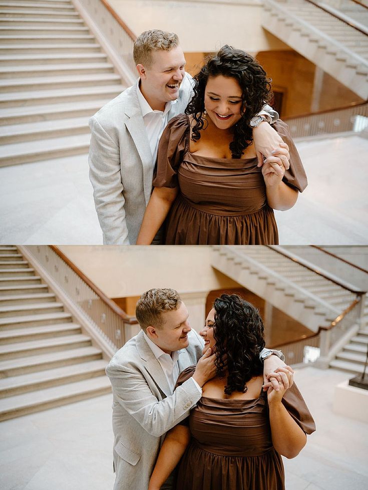 a man and woman standing next to each other in front of some stairs with their arms around each other