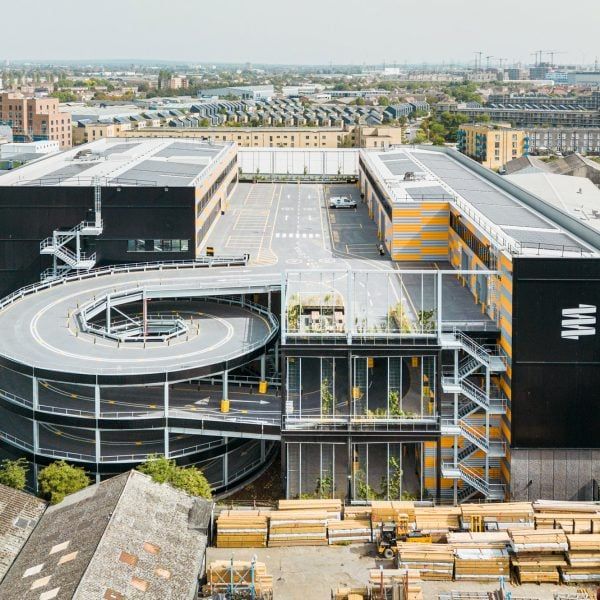 an aerial view of a large building with lots of parking spaces in front of it