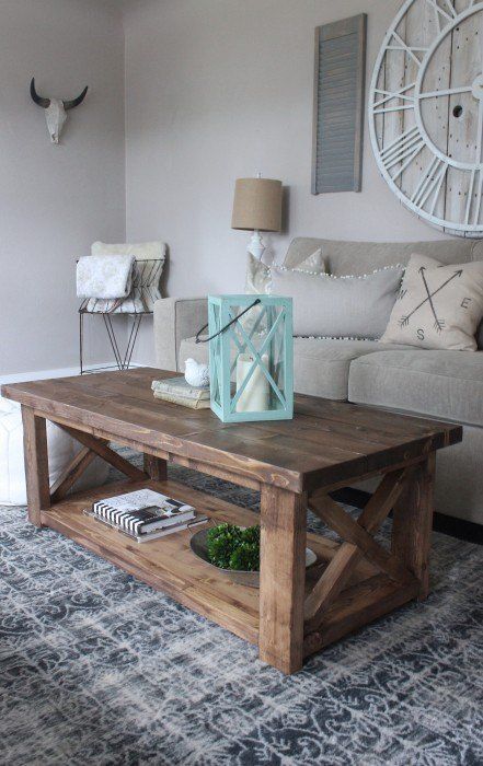 a living room with a couch, coffee table and clock on the wall above it