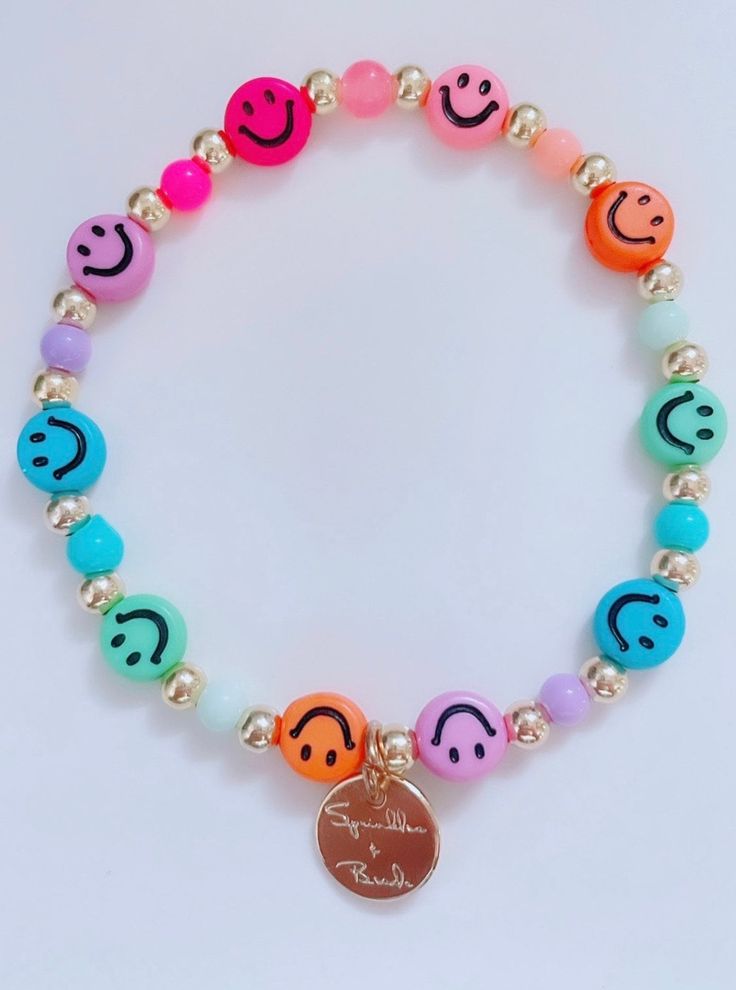 "This bracelet is handmade with love using some of our newest smiley face beads. **Please note the shipping time. This specific bracelet is a pre order, which means it will take anywhere between 1 to 2 weeks to arrive. To ensure a proper size, use a tape measure around your wrist. Place a dot where the tape measure meets. That is your wrist size! In our drop down menu, we have also included the average sizes for you. Please note we are not responsible if bracelet does not fit after providing thi Cheerful Adjustable Beaded Bracelets, Smiley Face Round Beads Bracelet For Gift, Smiley Face Round Beads Bracelet As Gift, Adjustable Smiley Face Bracelets As Gift, Adjustable Smiley Face Bracelet As Gift, Multicolor Smiley Face Bracelets As Gift, Casual Smiley Face Friendship Bracelets, Cheerful Handmade Beaded Bracelets, Playful Stretch Bracelet With Smiley Face For Gift