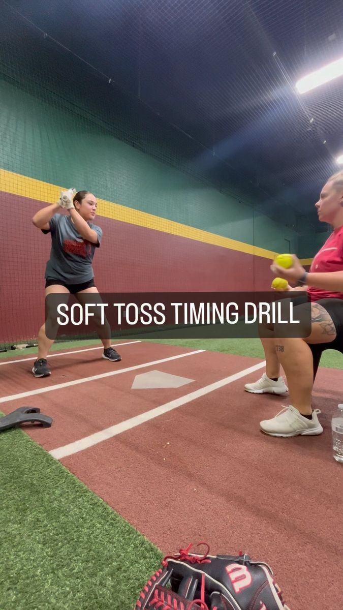 two women are playing softball in a batting cage with the words soft toss time drill