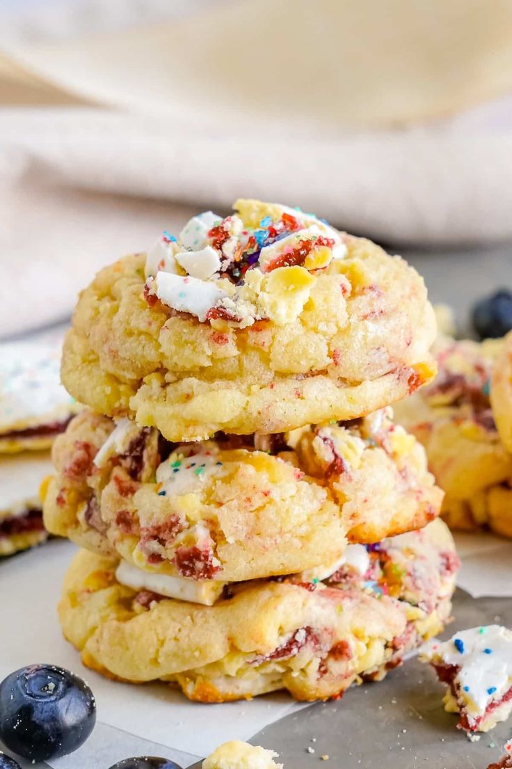 a stack of cookies with sprinkles and blueberries