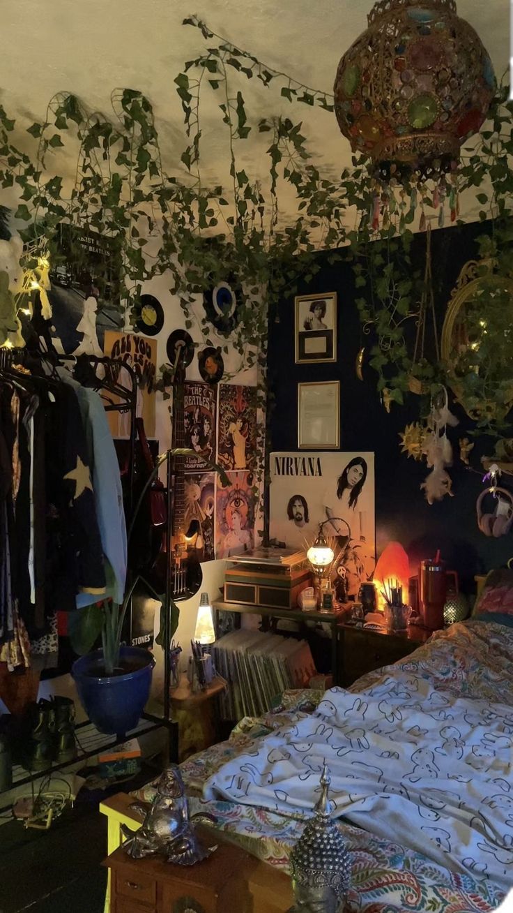 a bedroom with plants hanging from the ceiling, and pictures on the wall above it