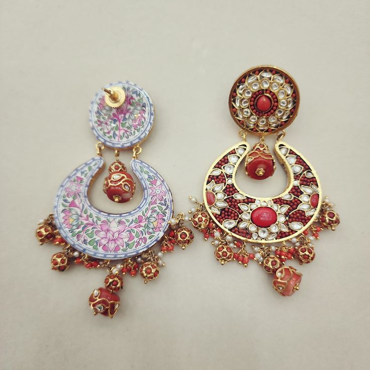 Enhance your look with these elegant Coral Chandbali Earrings. Featuring intricate designs with coral drops, these earrings bring a perfect blend of tradition and sophistication to any outfit. Ideal for festive occasions, they add a vibrant and graceful touch to your ensemble. Length: 3" to 3.5" Material: 24Kt gold foil, lac Stones: Kundans, semi precious corals, semi precious pearls Traditional Chandbali Earrings With Intricate Design, Meenakari Temple Jewelry Danglers, Festive Fusion Hoop Earrings For Celebration, Round Meenakari Chandelier Earrings, Temple Jewelry, Round Meenakari Chandelier Earrings In Temple Style, Round Meenakari Temple Jewelry Chandelier Earrings, Fusion Chandbali Earrings With Meenakari, Fusion Chandbali Meenakari Earrings, Chandbali Fusion Hoop Earrings For Celebration