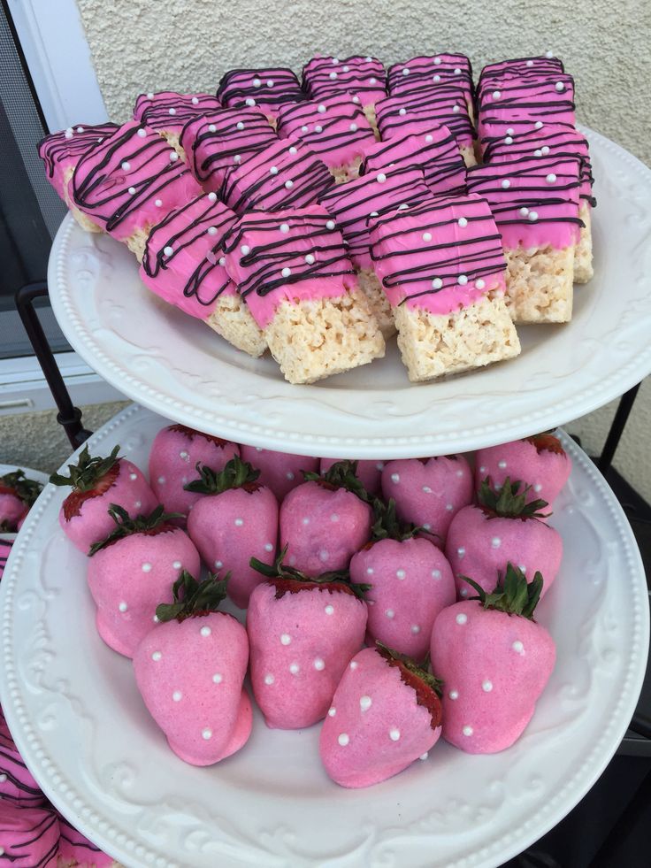 two tiered plates with strawberries and rice krispy treats