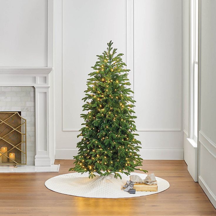 a small christmas tree sitting on top of a white rug