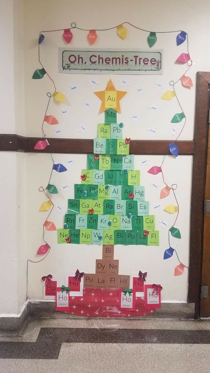 a christmas tree made out of letters on a bulletin board