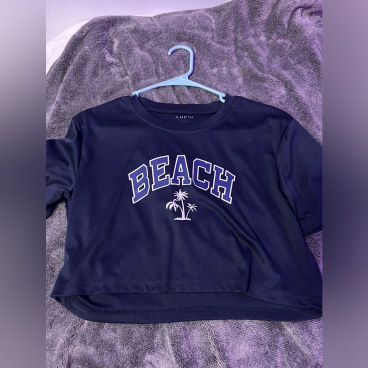 This Is A Navy Blue Crop Top That Says Beach On It And Big Letters, And It Is In Great Condition. Never Worn. Navy Blue Crop Top, Beach Tanks Tops, Gingham Jacket, Beach Tanks, Blue Crop Top, Nike Acg Jacket, Big Letters, Satin Long Sleeve, Blue Crop Tops