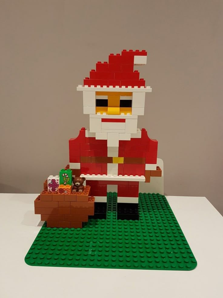 a lego santa clause is holding a toy sleigh