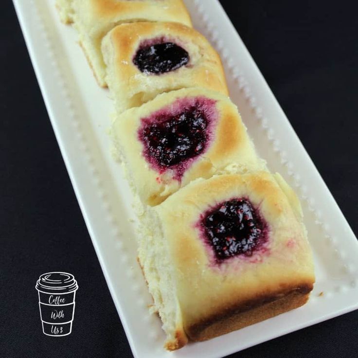 a white plate topped with slices of bread covered in jelly