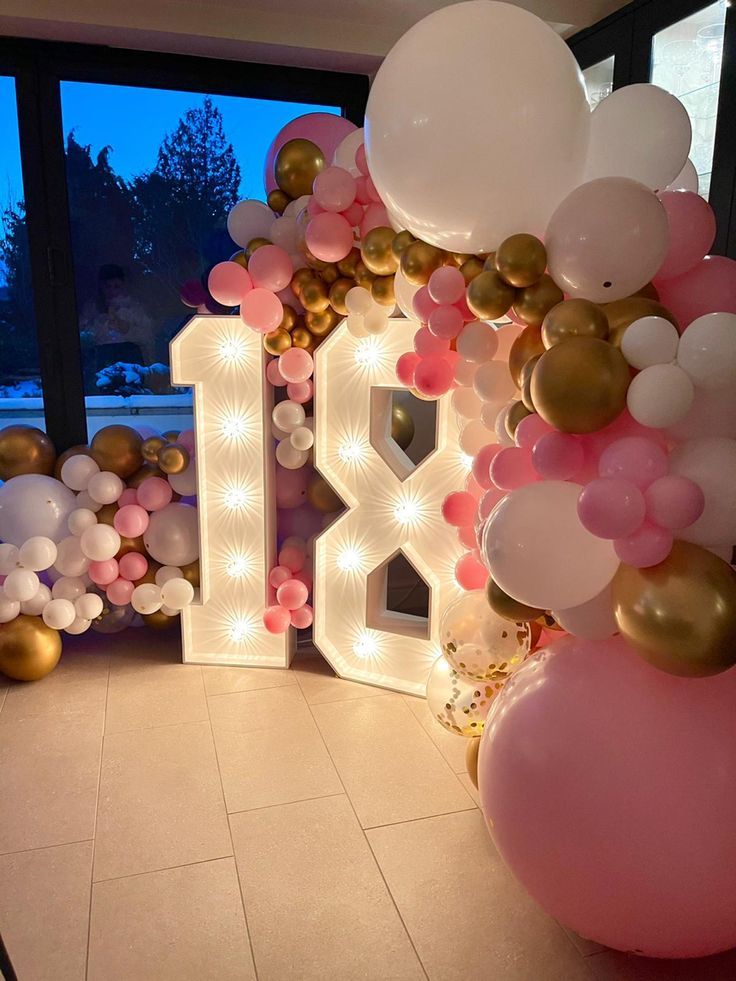 balloons and lights decorate the entrance to a birthday party