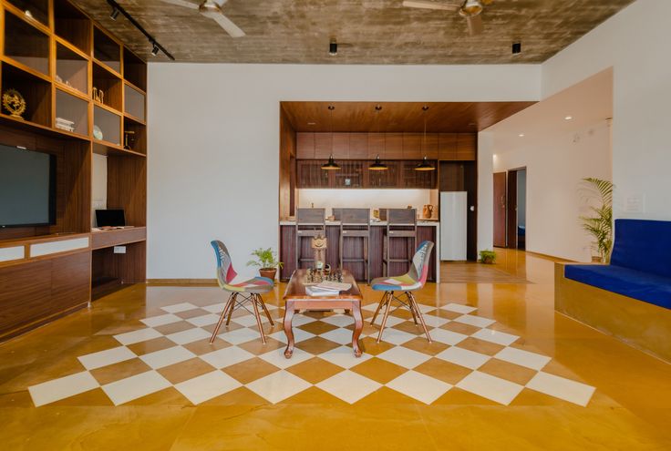 a living room filled with furniture and a flat screen tv sitting on top of a wooden shelf