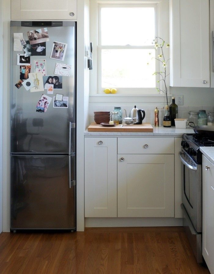 an image of a kitchen with white cabinets and stainless steel appliances on the appliance