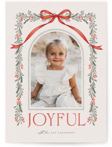 the joyful holiday card features an image of a baby in a frame with red ribbon