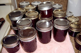 a bunch of jars that are sitting on a towel in front of a counter top