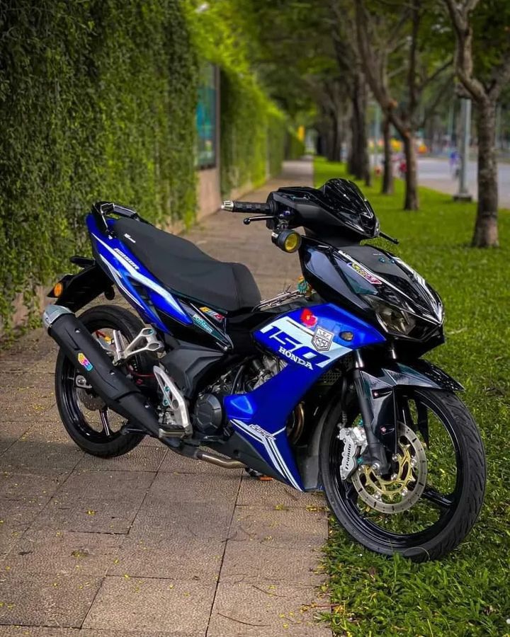 a blue motorcycle parked on the side of a road