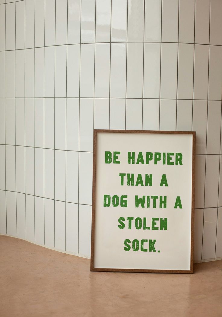 a sign that says be happier than a dog with a stolen sock on the floor