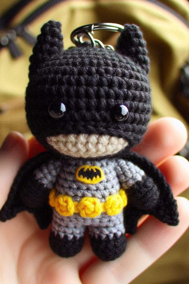 a small crocheted batman keychain is in someone's hand