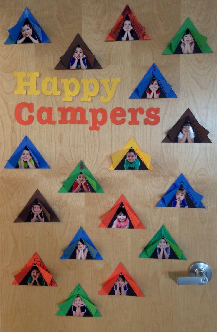 a door decorated with colorful paper houses and the words happy campers