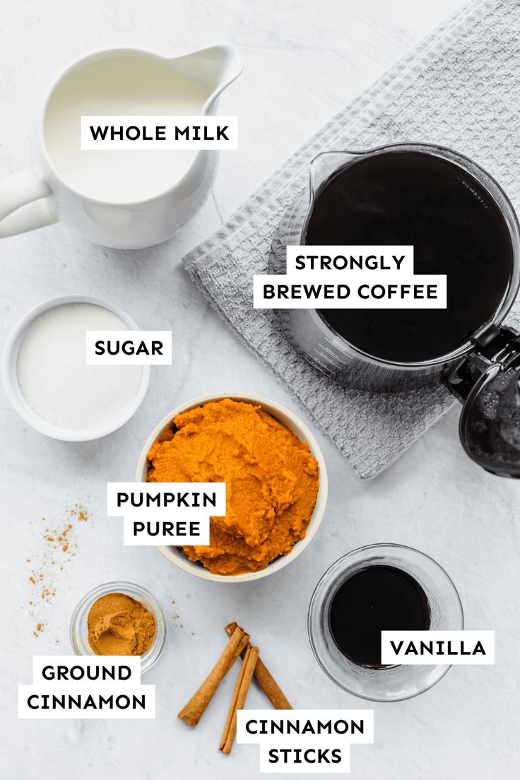 ingredients to make homemade pumpkin spice recipe on a white table with cinnamon sticks and milk