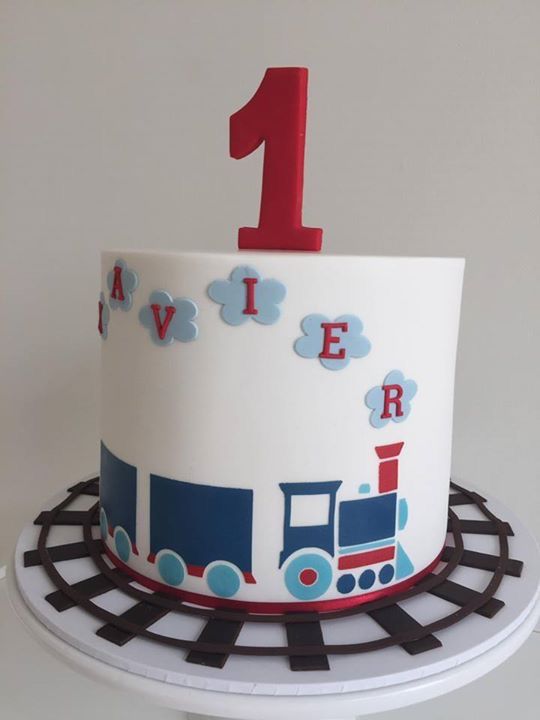 a train themed birthday cake with the number one on top