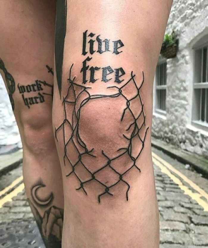 two legs with barbed wire on them and the words live free written in black ink