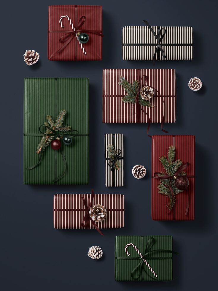 christmas presents wrapped in green and red paper with bows, pine cones and candy canes