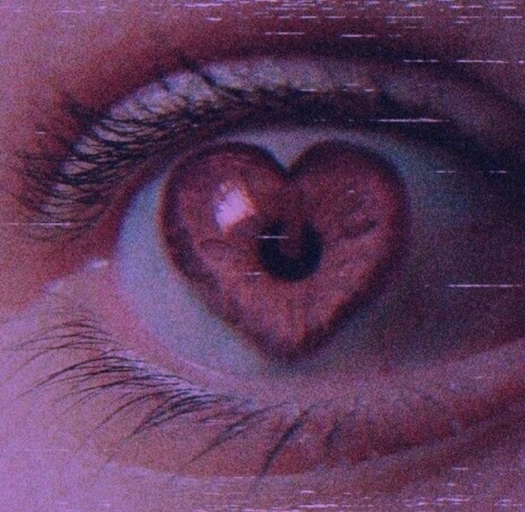 an eye with a heart - shaped object in the iris