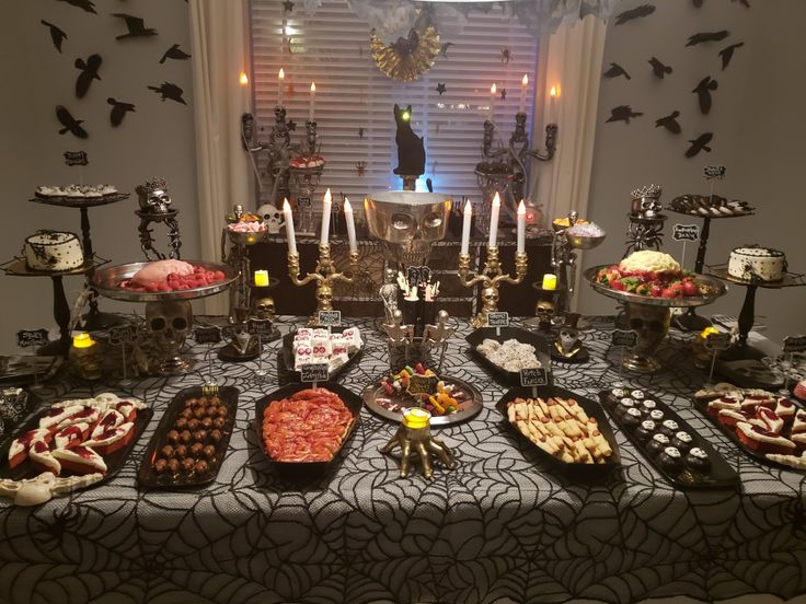 a table topped with lots of food and candles