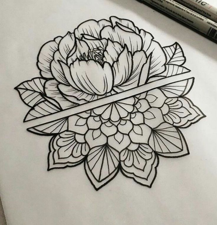 a drawing of a flower on paper next to a marker