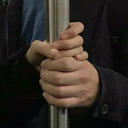 a person holding onto a pole with their hands