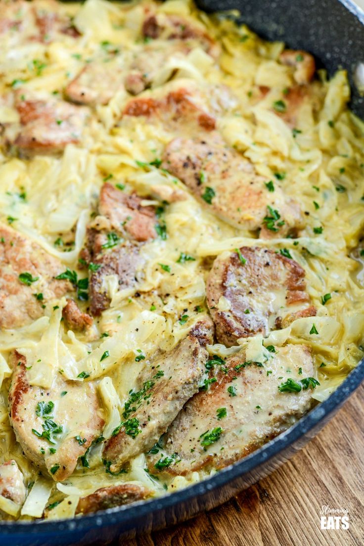 a skillet filled with pasta and meat covered in cheese