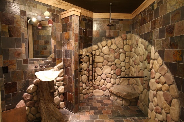 a bathroom with stone walls and tile flooring