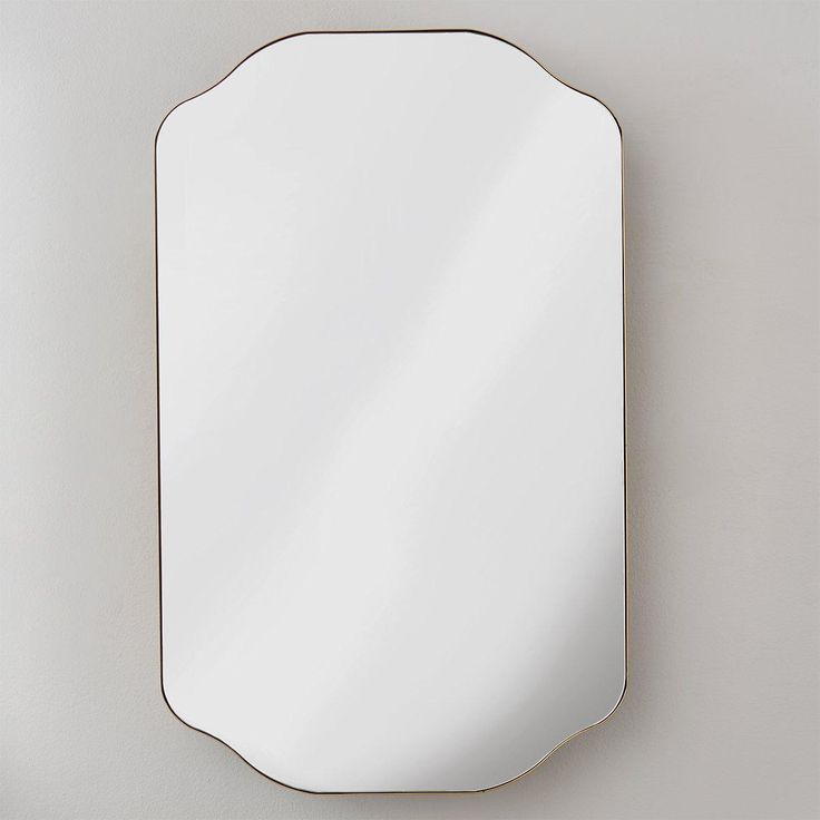 an oval mirror mounted on the wall