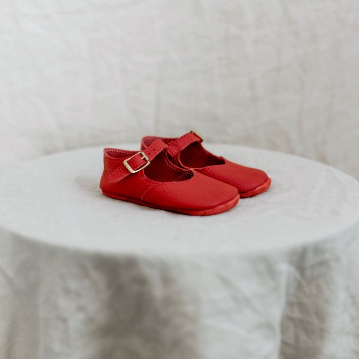 The Red Soft Soled Mary Jane is made of soft leather and features an adjustable ankle strap. Our soft soled shoes are non-restrictive and perfect for infants who aren’t quite walking yet. Soft Sole Closed Toe Mary Janes, Soft Sole Mary Janes, Red Leather Mary Janes With Flat Heel, Red Mary Janes With Buckle Closure For Spring, Red Leather Round Toe Mary Janes, Red Mary Janes With Buckle Closure, Red Mary Janes With Buckle Closure And Round Toe, Red Closed Toe Mary Janes With Buckle Closure, Non-slip Leather Mary Janes With Round Toe