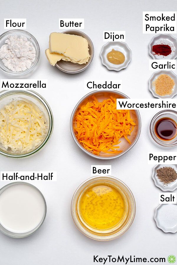 the ingredients to make cheesecakes are shown in bowls on a white table top